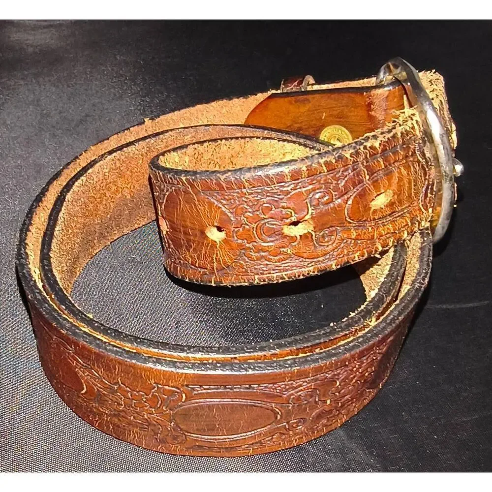 Tooled leather belt with a western vintage style, elaborate scroll design painte